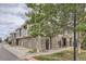 Exterior of townhome with stone and siding, attached garage, and landscaping at 12832 Mayfair Way # F, Englewood, CO 80112