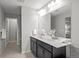 This bright bathroom features a double vanity, large mirror, and modern fixtures at 9756 Mount Kataka Pt, Littleton, CO 80125