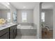Bright bathroom with a soaking tub, glass shower, double vanity, and a relaxing atmosphere at 9756 Mount Kataka Pt, Littleton, CO 80125