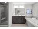 Elegant bathroom featuring a glass shower, soaking tub, double vanity, and luxurious finishes at 9756 Mount Kataka Pt, Littleton, CO 80125