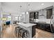 Modern kitchen with stainless steel appliances, an island, and opens up to the dining area at 9756 Mount Kataka Pt, Littleton, CO 80125