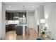Modern kitchen with stainless steel appliances, wood flooring and dark cabinets at 9756 Mount Kataka Pt, Littleton, CO 80125