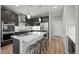 A modern kitchen with stainless steel appliances, a gas range and dark wood cabinets at 9756 Mount Kataka Pt, Littleton, CO 80125