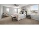 Sunlit main bedroom with a ceiling fan, multiple windows, and contemporary decor at 9756 Mount Kataka Pt, Littleton, CO 80125