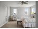 Relaxing main bedroom with a ceiling fan, two windows, and a comfortable sitting area at 9756 Mount Kataka Pt, Littleton, CO 80125