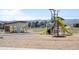Community playground featuring modern play structures, a slide, and a climbing area, with mountain views in the distance at 9756 Mount Kataka Pt, Littleton, CO 80125