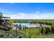 Community pool and spa area with lounge chairs surrounded by a lush green landscape and distant mountain views at 9756 Mount Kataka Pt, Littleton, CO 80125