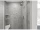 Modern shower featuring a rainfall shower head, tiled walls, and a built-in corner shelf at 9756 Mount Kataka Pt, Littleton, CO 80125