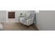 Cozy sitting area with a comfortable chair, throw blanket, and a round side table at 9756 Mount Kataka Pt, Littleton, CO 80125