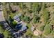 Aerial view of property showcasing home, garages, and wooded surroundings providing privacy and tranquility at 11531 S Deer Creek Rd, Littleton, CO 80127