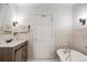 Charming bathroom featuring classic fixtures, tile accents, and a soaking tub at 11531 S Deer Creek Rd, Littleton, CO 80127