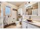 Stylish bathroom featuring custom vanity, vessel sink, and decorative tile accents at 11531 S Deer Creek Rd, Littleton, CO 80127