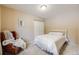 Cozy bedroom with a single bed, chair, and closet for storage at 11531 S Deer Creek Rd, Littleton, CO 80127