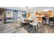 Open dining area with table and chairs seamlessly connects to the living room and kitchen, great for entertaining at 11531 S Deer Creek Rd, Littleton, CO 80127