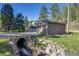 Garage located next to creek with rocky shores for peaceful sounds and scenery at 11531 S Deer Creek Rd, Littleton, CO 80127