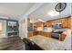 A bright kitchen with wood cabinets, granite countertops, and a breakfast bar offers a functional and inviting space at 11531 S Deer Creek Rd, Littleton, CO 80127