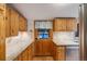 Kitchen with wooden cabinets, granite countertops, and stainless-steel appliances at 11531 S Deer Creek Rd, Littleton, CO 80127