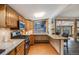 Charming kitchen with wooden cabinets, granite countertops and eat in bar area at 11531 S Deer Creek Rd, Littleton, CO 80127