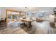 Expansive living room with wooden beams, dining area, and a cozy sitting area offers versatile living spaces at 11531 S Deer Creek Rd, Littleton, CO 80127