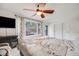 Inviting main bedroom with large windows, deck access, and a ceiling fan at 11531 S Deer Creek Rd, Littleton, CO 80127