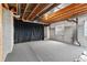 Spacious unfinished basement featuring concrete walls and ceiling with exposed wood and utilities at 7630 Chickaree Pl, Littleton, CO 80125