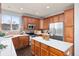 Updated kitchen featuring wood cabinets, stainless steel appliances, quartz countertops, and ample counter space at 7630 Chickaree Pl, Littleton, CO 80125