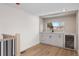 Stylish bar area with sleek white cabinets, modern black faucet, and a wine cooler next to the window at 535 Josephine St, Denver, CO 80206