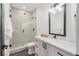 Contemporary bathroom showcasing a glass shower with beige tiles, stylish vanity with marble countertops and black fixtures at 535 Josephine St, Denver, CO 80206