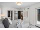 Comfortable bedroom with a patterned bedspread, white walls, and multiple doorways leading to other areas of the home at 535 Josephine St, Denver, CO 80206