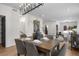 Elegant dining area with a modern chandelier, wood table, and comfortable seating for Gathering gatherings at 535 Josephine St, Denver, CO 80206