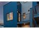 Modern home exterior highlighting a private balcony with metal railings and a sleek blue and brick facade under a twilight sky at 535 Josephine St, Denver, CO 80206