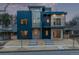 Modern home featuring unique blue siding and brick accents, complemented by private balconies at 535 Josephine St, Denver, CO 80206