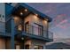 Modern home exterior featuring a private balcony and contemporary design elements with a striking combination of brick and wood at 535 Josephine St, Denver, CO 80206