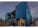 Modern townhouse exterior featuring a balcony and sliding glass doors for seamless indoor-outdoor living at 535 Josephine St, Denver, CO 80206