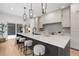 Modern kitchen with sleek white countertops, pendant lighting, and seating at the large kitchen island at 535 Josephine St, Denver, CO 80206