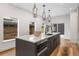 Modern kitchen island with black fixtures, sleek countertops, and modern pendant lighting, offering ample space for cooking and dining at 535 Josephine St, Denver, CO 80206