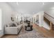 Bright and airy living room featuring hardwood floors, a comfortable sofa, and a stylish round mirror and coffee table at 535 Josephine St, Denver, CO 80206