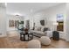 Bright living room with hardwood floors, a plush sofa, round coffee table, and large windows offering natural light at 535 Josephine St, Denver, CO 80206