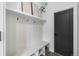 Functional mudroom with built-in bench, coat hooks, storage shelves, and a dark-colored door for a modern touch at 535 Josephine St, Denver, CO 80206