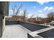 Spacious rooftop patio with snow-covered ground and views of surrounding buildings at 535 Josephine St, Denver, CO 80206