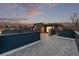 Wide rooftop deck view highlighting the spacious layout and sleek design against a twilight sky at 535 Josephine St, Denver, CO 80206