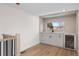 Light filled wet bar with white cabinets, granite countertops, wine fridge and view from large window at 535 Josephine St, Denver, CO 80206