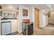 Basement bar area featuring a mini fridge, a wine cooler, and an open doorway at 5774 Sioux Dr, Sedalia, CO 80135