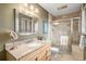 Bathroom featuring granite countertops, a glass-enclosed shower with tile, and modern fixtures offers elegance at 5774 Sioux Dr, Sedalia, CO 80135