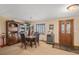 Cozy dining room featuring a classic wooden table set, bookcase, and wine cooler near a window at 5774 Sioux Dr, Sedalia, CO 80135