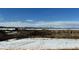 Mountain view of snowy landscape with some dry brush under a blue sky at 5774 Sioux Dr, Sedalia, CO 80135