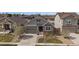 Aerial view of home, showing its well-manicured lawn, convenient two-car garage, and neutral toned exterior at 6747 W Jewell Pl, Lakewood, CO 80227