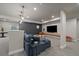 Finished basement with gray walls, a bar area, and a comfortable couch at 6747 W Jewell Pl, Lakewood, CO 80227