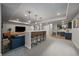 Finished basement featuring a bar, TV, and a cozy seating area at 6747 W Jewell Pl, Lakewood, CO 80227