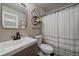 Bathroom featuring a modern vanity, toilet, and shower with a stylish curtain and geometric wall decor at 6747 W Jewell Pl, Lakewood, CO 80227
